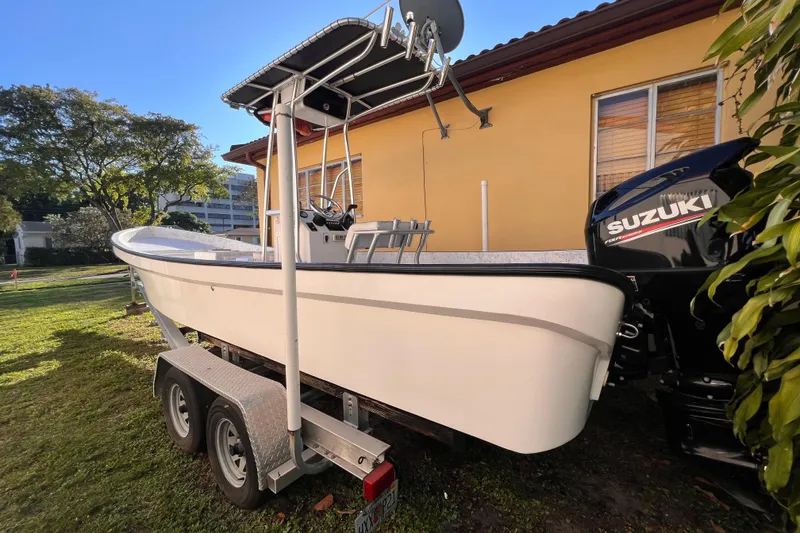 Slide: The Image of Suzuki four-stroke outboard motor on a 2017 Panga Minsa boat, surrounded by greenery. - 7
