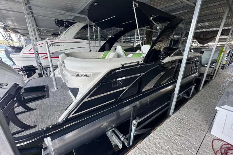 Slide: The Image of 2022 Bennington QX 25 Quad Bench with Yamaha XTO outboard motor in marina. - 11