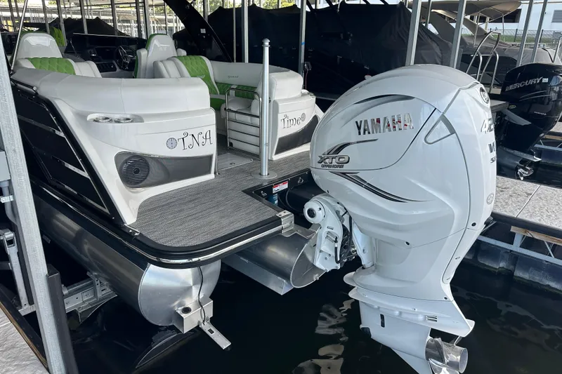 Slide: The Image of 2022 Bennington QX 25 Quad Bench pontoon boat docked in marina. - 16