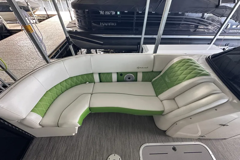 Slide: The Image of 2022 Bennington QX 25 Quad Bench pontoon boat docked at marina. - 30