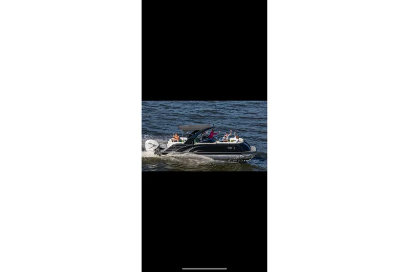 Slide: The Image of 2022 Bennington QX 25 Quad Bench with green and white seating in a boat interior. - 6