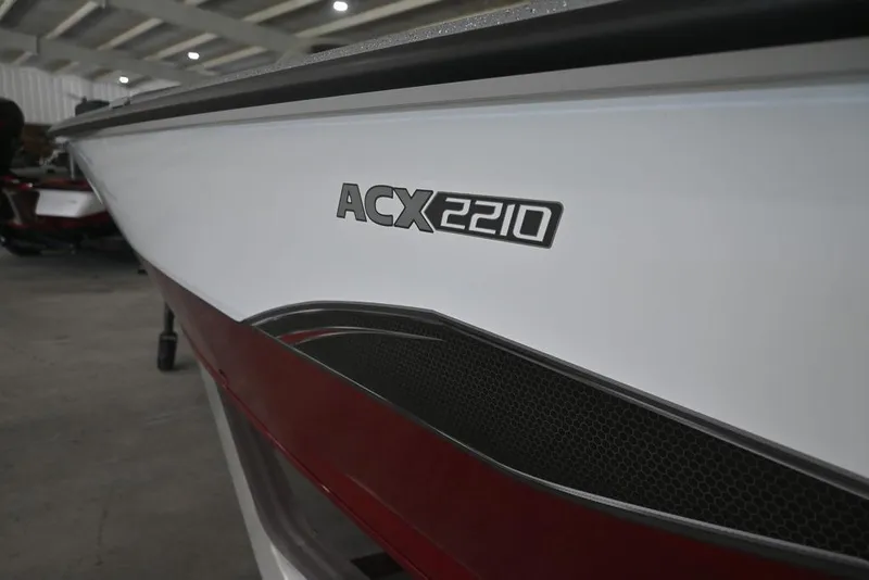Slide: The Image of 2026 Vexus ACX 2210 boat in showroom, close-up of model name on hull. - 4