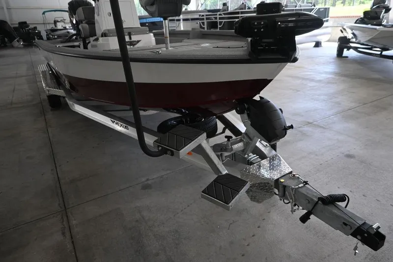 Slide: The Image of 2026 Vexus ACX 2210 boat on trailer in indoor showroom setting. - 5