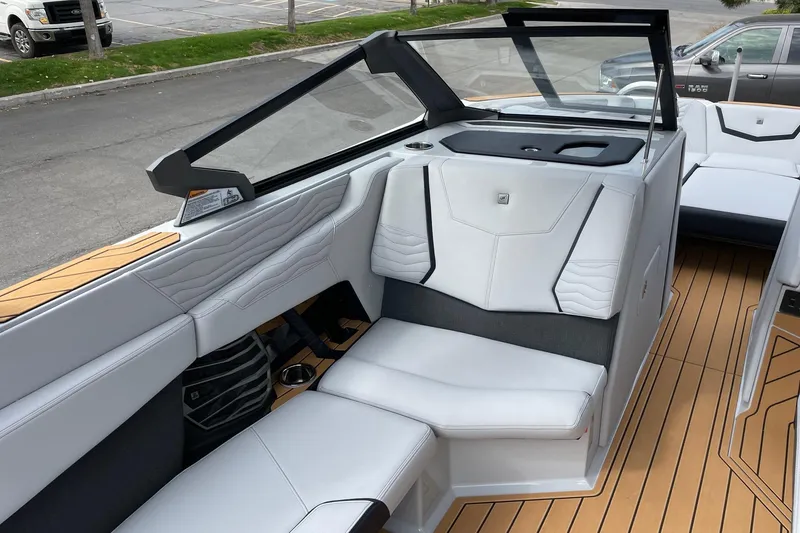 Slide: The Image of 2026 Nautique Super Air Nautique G25 interior with sleek white seating and modern design. - 10