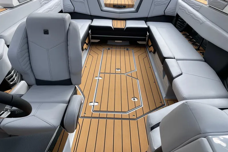 Slide: The Image of Luxurious interior of 2026 Nautique Super Air Nautique G25 with sleek seating and wood flooring. - 12
