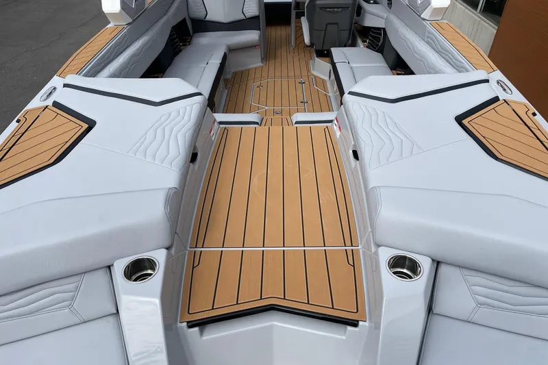 Slide: The Image of 2026 Nautique Super Air Nautique G25 interior with sleek seating and teak-style flooring. - 4