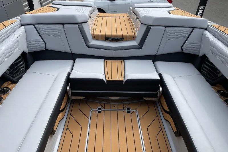 Slide: The Image of 2026 Nautique Super Air Nautique G25 interior with luxurious seating and teak flooring. - 8