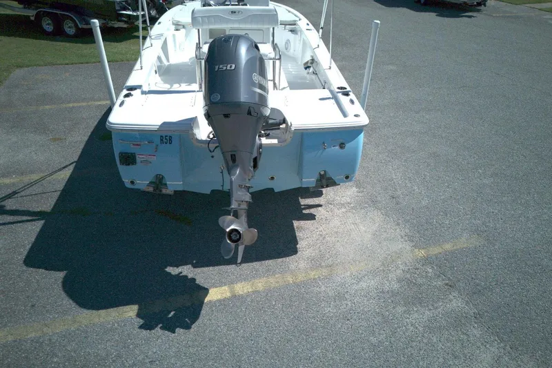 Slide: The Image of 2017 Sea Hunt BX 22 BR boat with Yamaha 150 outboard motor, parked on asphalt. - 2