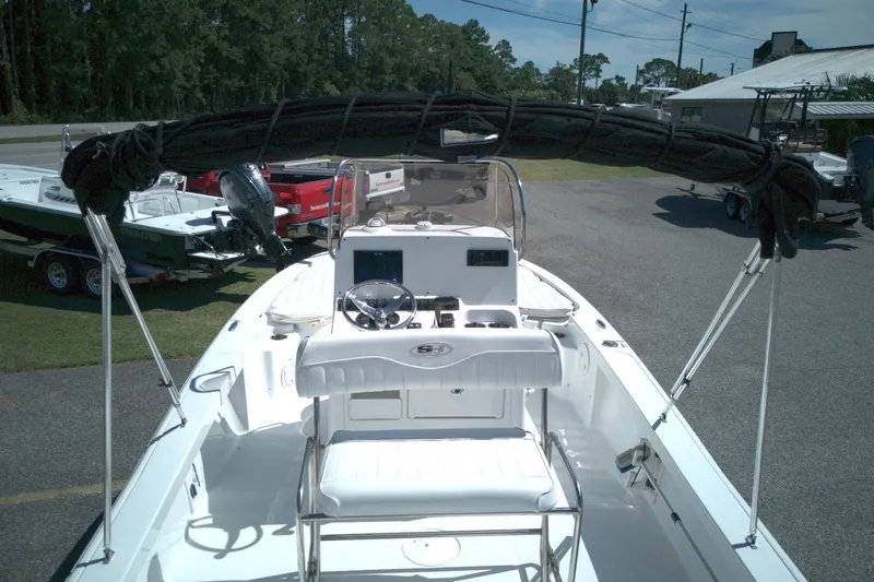 Slide: The Image of 2017 Sea Hunt BX 22 BR boat with console and seating, parked outdoors. - 8