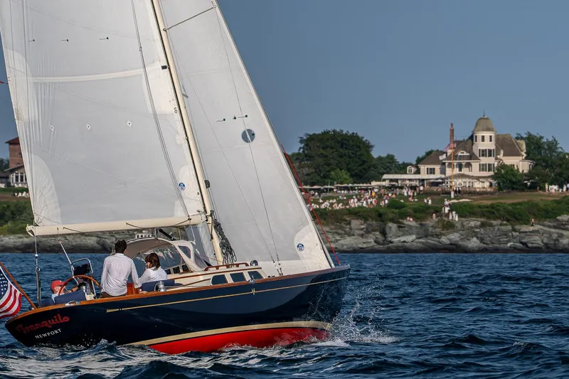 Slide: The Image of Sailing yacht Morris M36, 2008 model, gliding near scenic coastal estate. - 6
