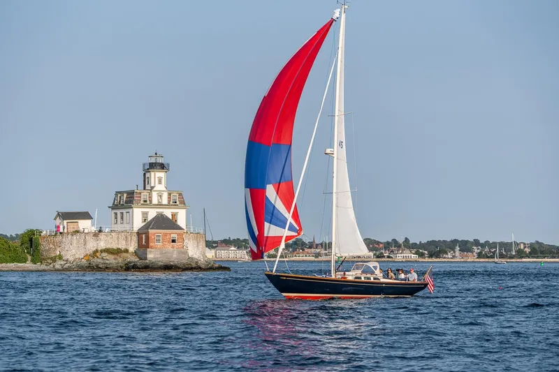 Slide: The Image of 2008 Morris Yachts M36 sailing near a historic lighthouse on a sunny day. - 8