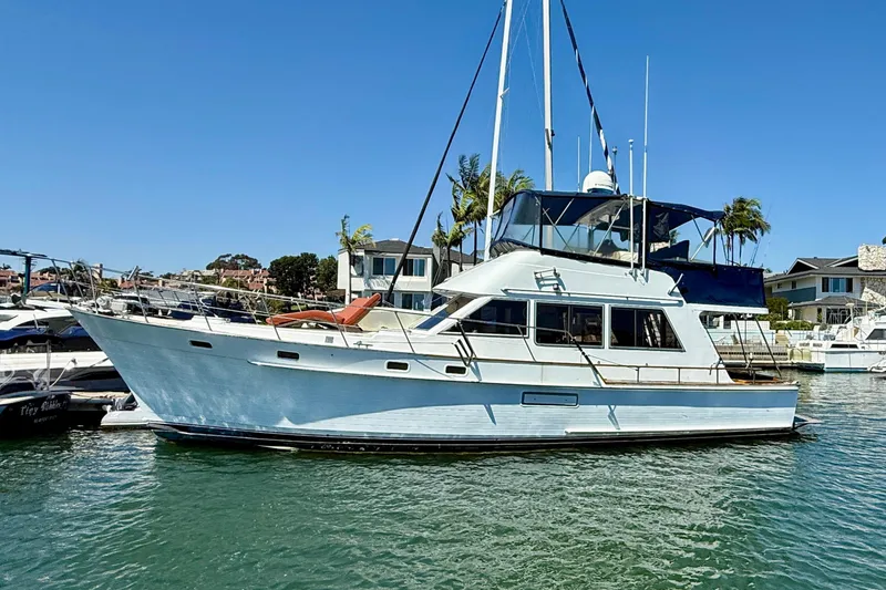 The Image of 1991 Kong & Halvorsen Island Gypsy yacht docked in a marina under clear blue skies. - 0