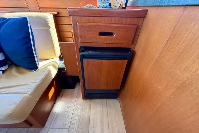 Slide: The Image of 1991 Kong & Halvorsen Island Gypsy interior with wooden cabinetry and cushioned seating. - 10