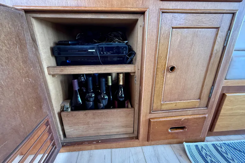 Slide: The Image of Wooden cabinet on 1991 Kong & Halvorsen Island Gypsy yacht, storing wine bottles and electronics. - 12