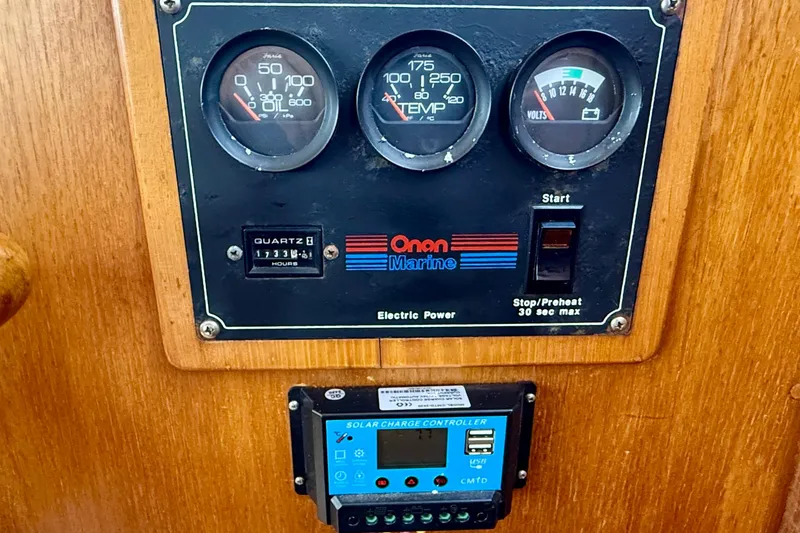 Slide: The Image of Control panel of a 1991 Kong & Halvorsen Island Gypsy boat with gauges and solar charge controller. - 14