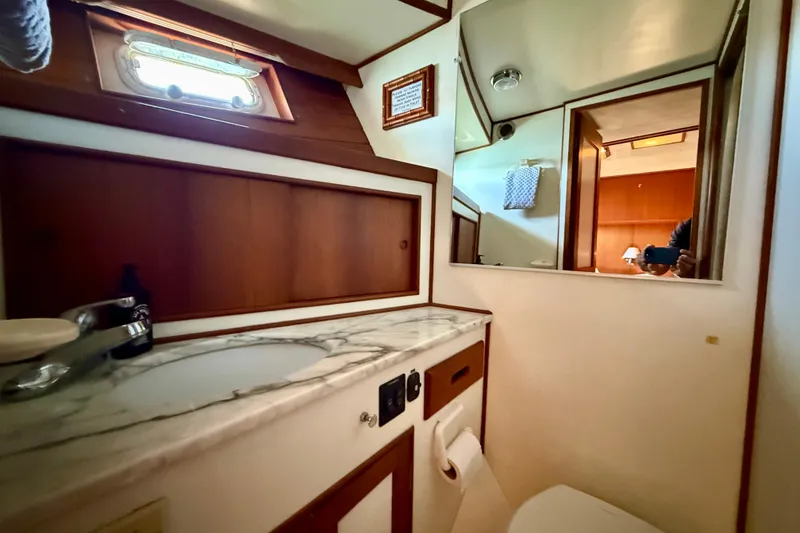 Slide: The Image of Bathroom interior of 1991 Kong & Halvorsen Island Gypsy yacht with marble countertop. - 19