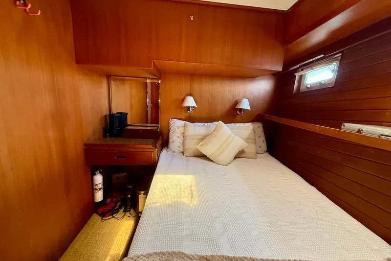 Slide: The Image of Cozy cabin interior of 1991 Kong & Halvorsen Island Gypsy yacht with wooden paneling and bed. - 22