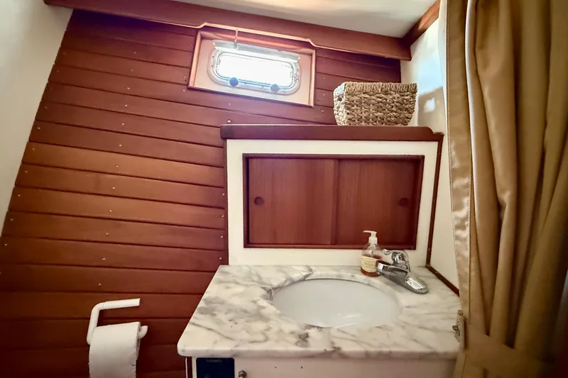 Slide: The Image of 1991 Kong & Halvorsen Island Gypsy yacht bathroom with marble sink and wooden accents. - 23