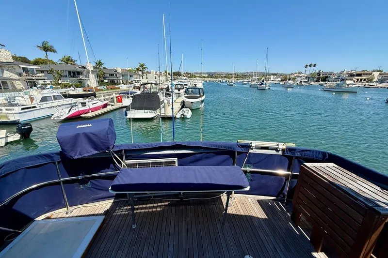 Slide: The Image of 1991 Kong & Halvorsen Island Gypsy yacht docked in a scenic marina with clear blue skies. - 36