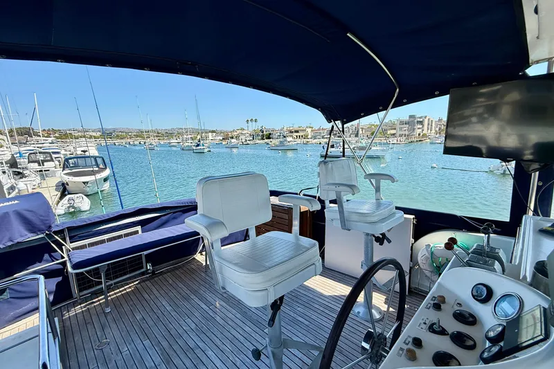 Slide: The Image of 1991 Kong & Halvorsen Island Gypsy yacht interior with helm, chairs, and marina view. - 38