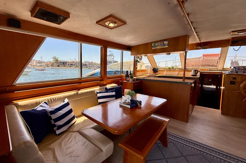 Slide: The Image of Interior of 1991 Kong & Halvorsen Island Gypsy yacht with dining area and scenic window view. - 4