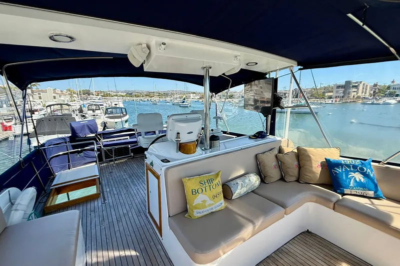 Slide: The Image of 1991 Kong & Halvorsen Island Gypsy yacht interior with seating, cushions, and marina view. - 42