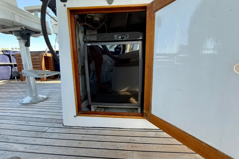 Slide: The Image of 1991 Kong & Halvorsen Island Gypsy yacht interior with open cabinet and mini fridge. - 49