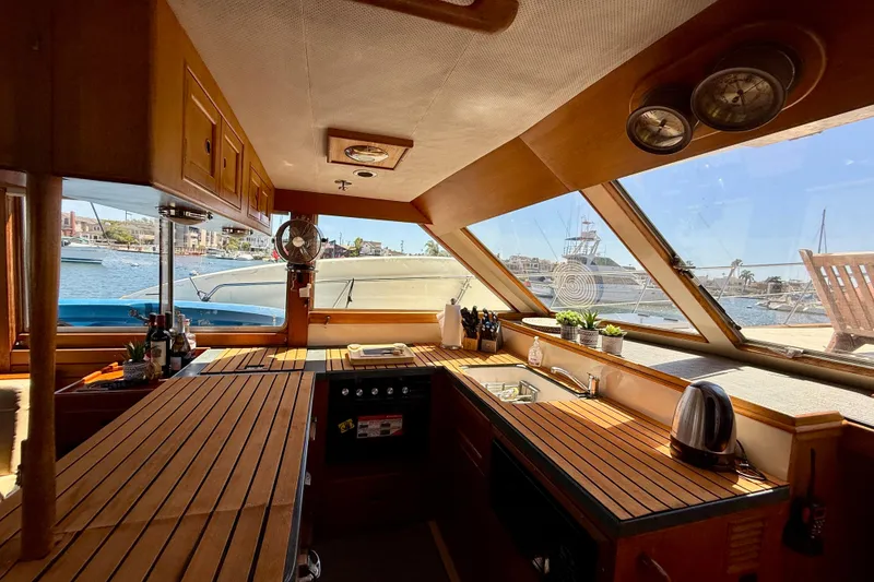 Slide: The Image of Interior of 1991 Kong & Halvorsen Island Gypsy yacht with wooden kitchen and scenic harbor view. - 8