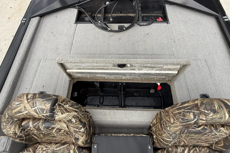 Slide: The Image of 2011 Bass Tracker PRO TEAM 190 TX boat interior with camo seats and storage compartment. - 12