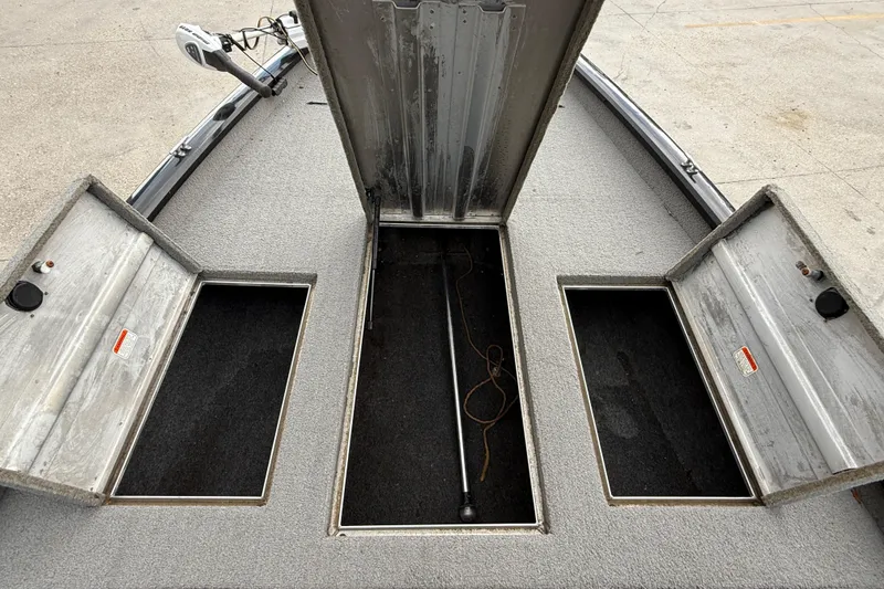 Slide: The Image of 2011 Bass Tracker PRO TEAM 190 TX boat storage compartments open on deck. - 13