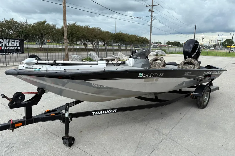 Slide: The Image of 2011 Bass Tracker PRO TEAM 190 TX fishing boat on trailer, parked outdoors. - 4