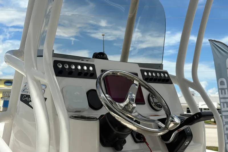 Slide: The Image of 2022 Robalo 206 Cayman boat console with steering wheel and controls. - 10