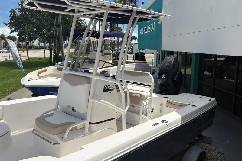Slide: The Image of 2022 Robalo 206 Cayman boat displayed outdoors at a dealership. - 12