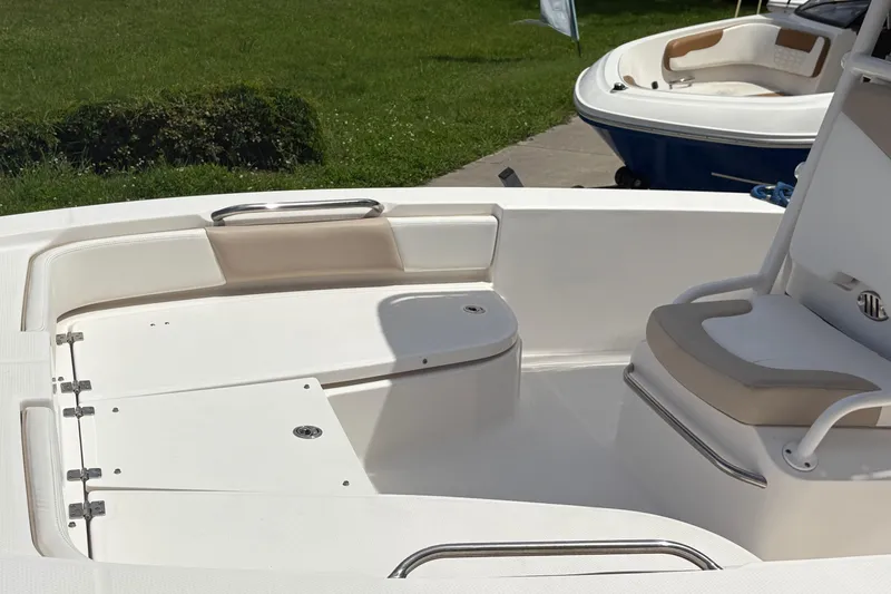 Slide: The Image of 2022 Robalo 206 Cayman boat interior with seating and storage compartments. - 13