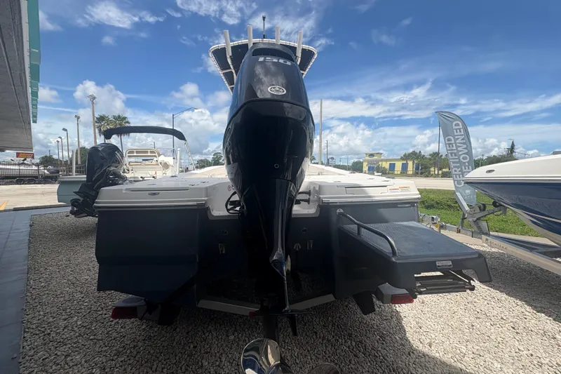 Slide: The Image of 2022 Robalo 206 Cayman boat displayed outdoors, rear view with outboard motor. - 5