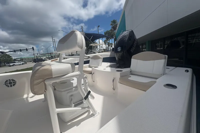 Slide: The Image of 2022 Robalo 206 Cayman boat interior with seating and Suzuki outboard motor. - 7