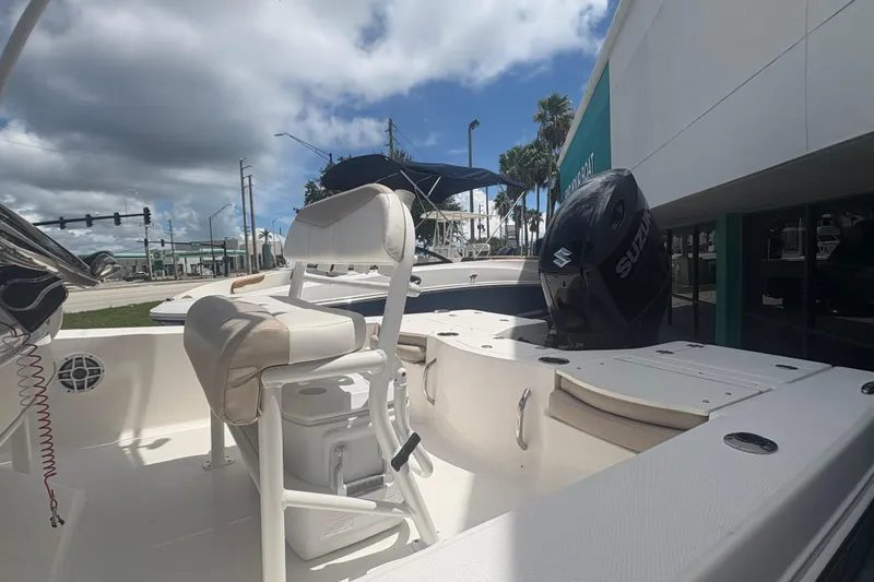 Slide: The Image of 2022 Robalo 206 Cayman boat interior with seating and Suzuki outboard motor. - 8