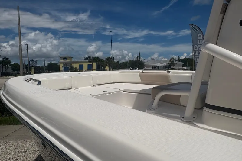 Slide: The Image of 2022 Robalo 206 Cayman boat, white deck, outdoor display, sunny day, blue sky. - 9
