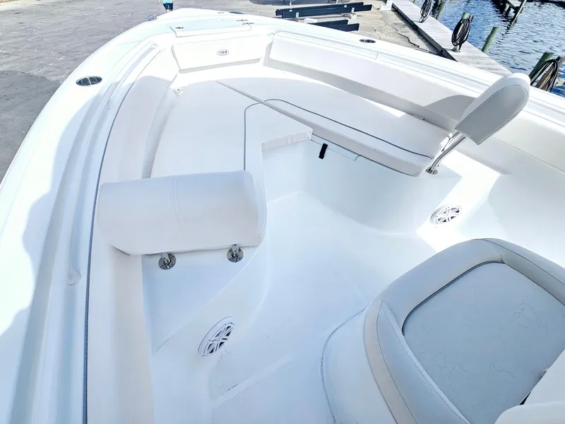 Slide: The Image of 2025 Sea Hunt Ultra 239 SE boat interior with white seating and deck. - 13