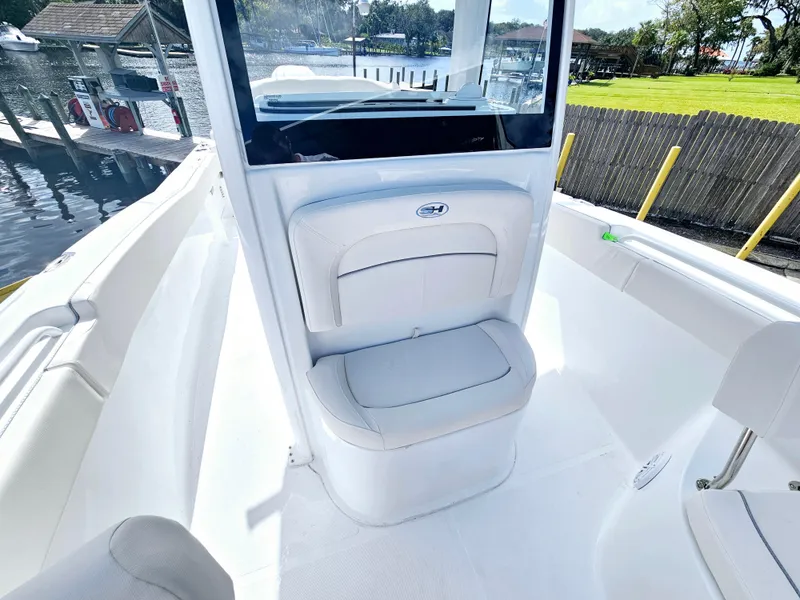 Slide: The Image of 2025 Sea Hunt Ultra 239 SE boat interior with white seating and console. - 15