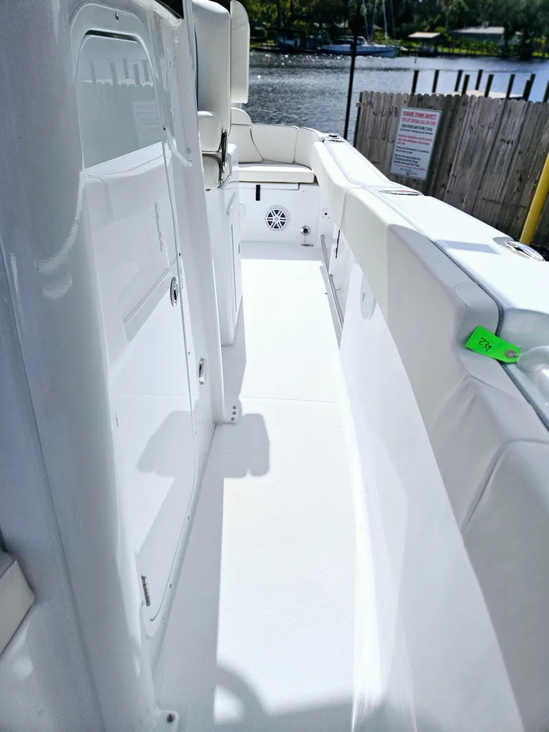 Slide: The Image of 2025 Sea Hunt Ultra 239 SE boat interior, featuring sleek white deck and seating. - 17