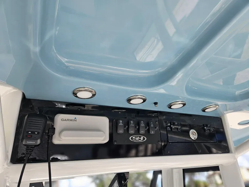 Slide: The Image of 2025 Sea Hunt Ultra 239 SE boat console with Garmin electronics and control panel. - 18