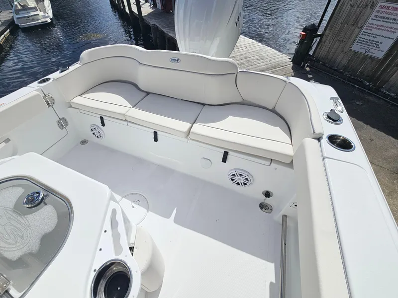 Slide: The Image of 2025 Sea Hunt Ultra 239 SE boat interior with cushioned seating and cup holders. - 21