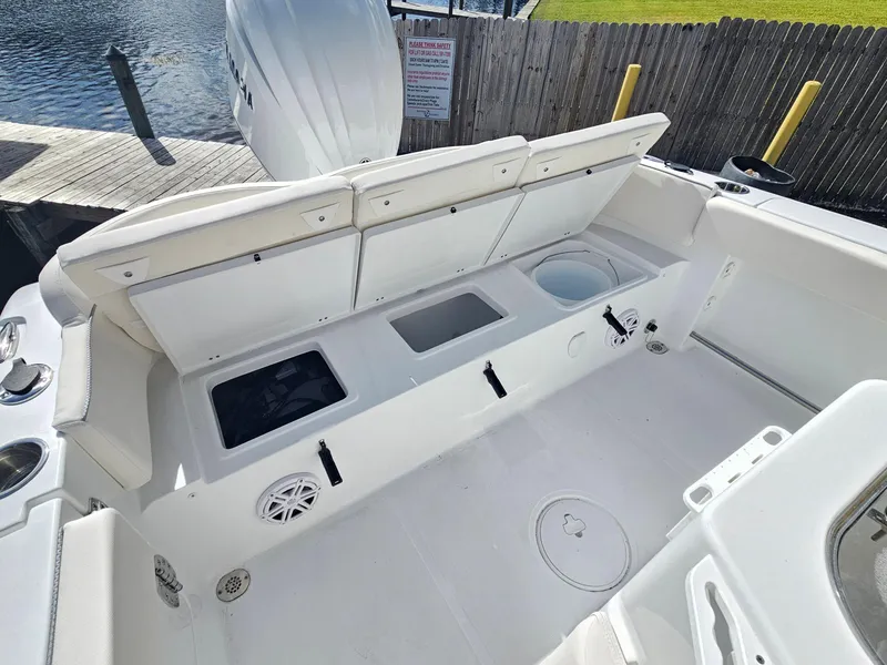 Slide: The Image of 2025 Sea Hunt Ultra 239 SE boat interior with open storage compartments and seating. - 22