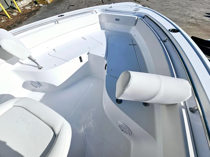 Slide: The Image of 2025 Sea Hunt Ultra 239 SE boat interior with white seating and storage compartments. - 27