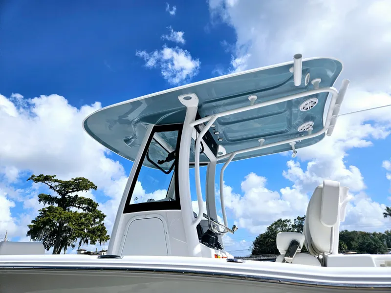 Slide: The Image of 2025 Sea Hunt Ultra 239 SE boat with T-top against a blue sky. - 3