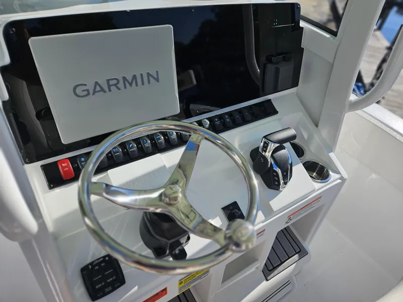 Slide: The Image of 2025 Sea Hunt Ultra 239 SE boat dashboard with Garmin navigation system and steering wheel. - 19