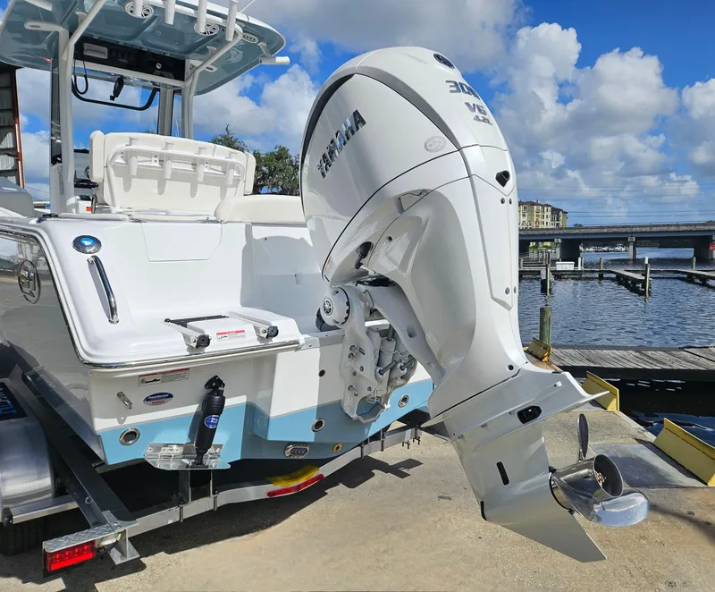 Slide: The Image of 2025 Sea Hunt Ultra 239 SE boat with Yamaha outboard motor at a dock. - 8