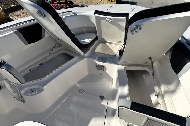 Slide: The Image of 2025 Robalo R270 Center Console boat with open storage compartments. - 11