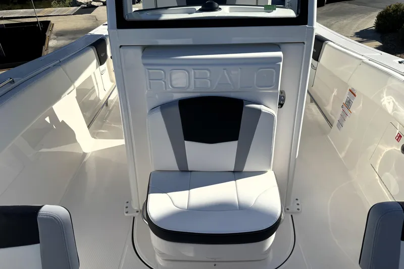 Slide: The Image of 2025 Robalo R270 Center Console boat interior with cushioned seating. - 15